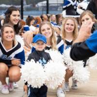 Little Laker poses with Laker Cheerleaders